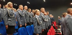 Zdjęcie kolorowe, policjanci stojący w sali kinowej ChDK